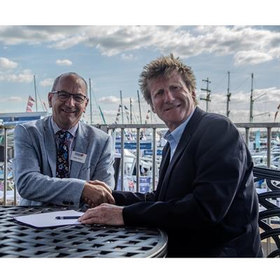 Robert Parton, president of British Marine, and James Walters, managing director of Walcon Marine,  signing the contract